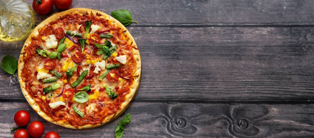 istock Delicious vegetarian pizza served on wooden table 1180800078