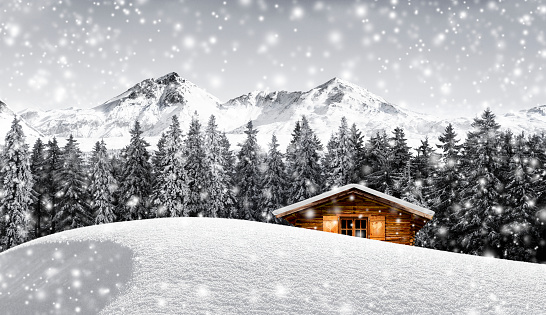 Log cabin in snowy mountain landscape