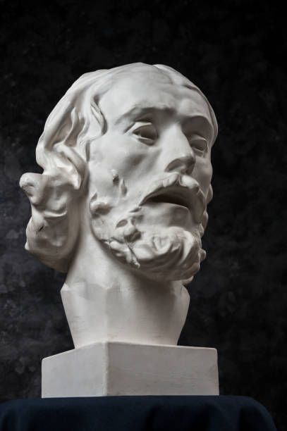 istock Gypsum copy of ancient statue John the Baptist head on dark textured background. Plaster sculpture man face. 1180802425