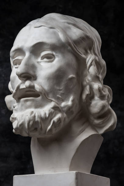 istock Gypsum copy of ancient statue John the Baptist head on dark textured background. Plaster sculpture man face. 1180802447