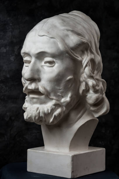 istock Gypsum copy of ancient statue John the Baptist head on dark textured background. Plaster sculpture man face. 1180802449