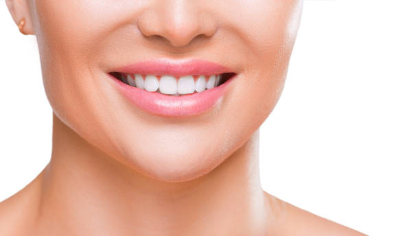 istock Woman's smile with white healthy teeth, close up view - isolated on white background. 1180802550