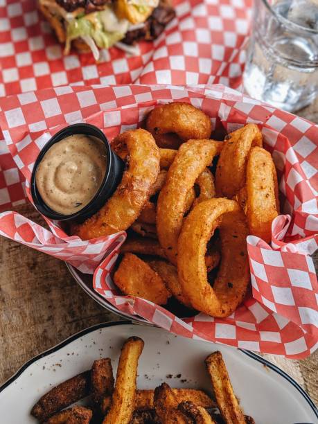 istock Onion rings basket in restaurant, vertical portrait view. 1180802734