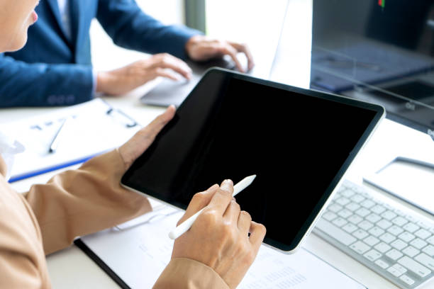 istock business man and woman sit at the table 1180802791