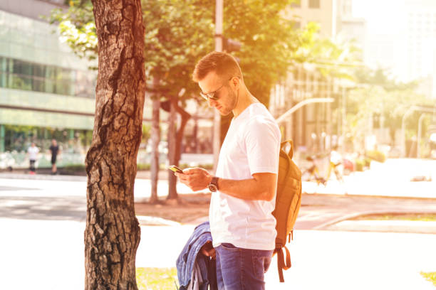 istock Young man waiting for a taxi 1180804895