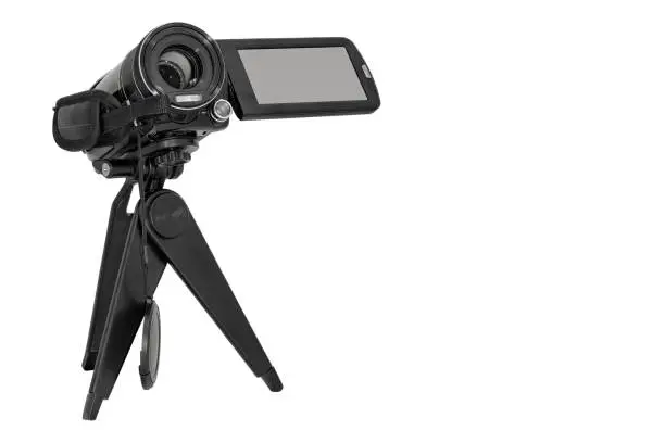 Compact camcorder on a tripod. Close-up. Isolated on white background. Place for text.