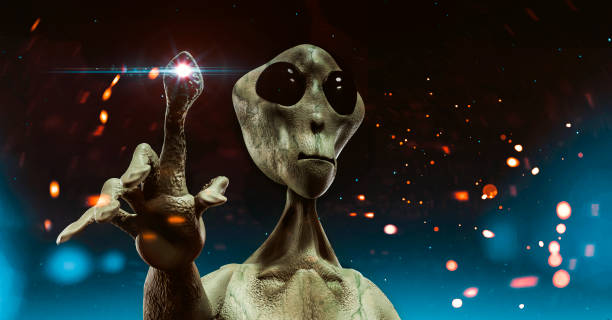 Alien from outer space stands before sky filled with stars trying to communicate Alien with big head and large eyes stands still. He points with his finger and light emerges from it. The alien does not look friendly. Maybe is about to attack. military invasion photos stock pictures, royalty-free photos & images