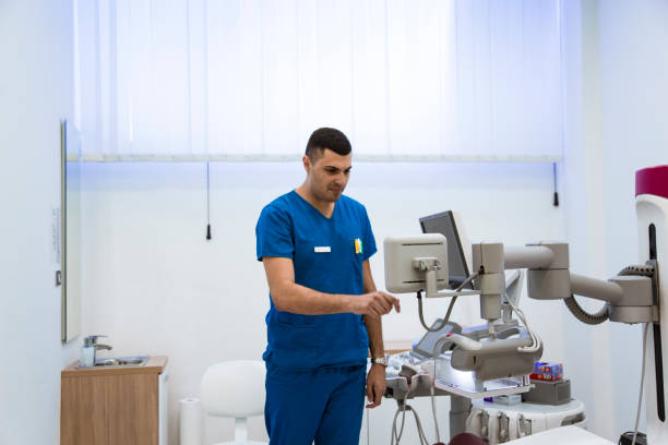 istock Doctor examining  breasts with mammograph 1180809732