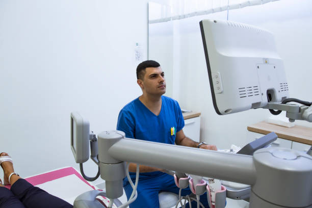 istock Doctor examining  breasts with mammograph 1180810300