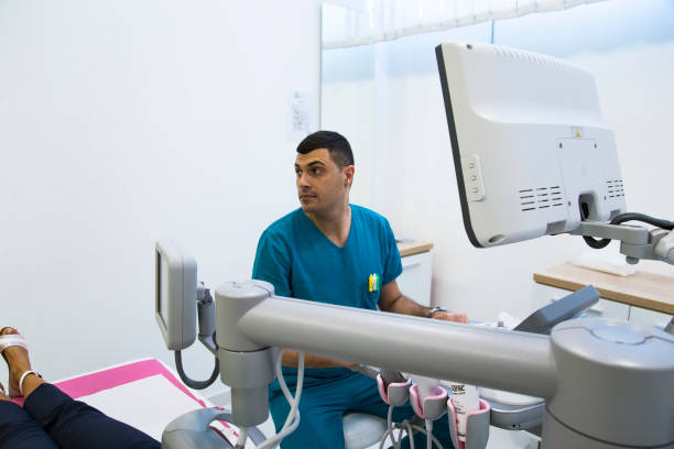 istock Doctor examining  breasts with mammograph 1180810566