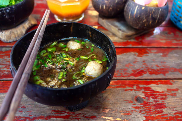 Thai noodles in wood bowl coconut shell and chopsticks  Handmade on Wooden table Thai noodles in wood bowl coconut shell and chopsticks  Handmade on Wooden table beef pad stock pictures, royalty-free photos & images