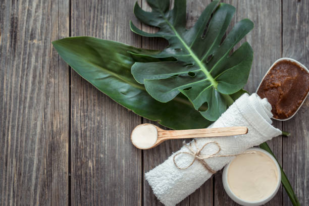istock Spa composition with towels and tropical leaf on a wooden background. 1180812716