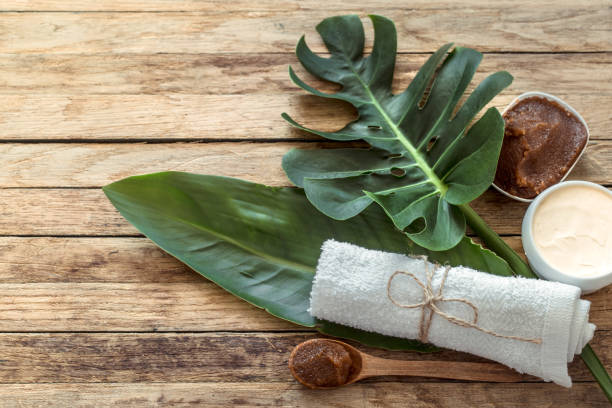 istock Spa composition with towels and tropical leaf on a wooden background. 1180812726