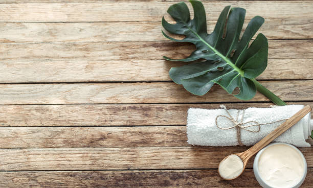 istock Spa composition with towels and tropical leaf on a wooden background. 1180812727