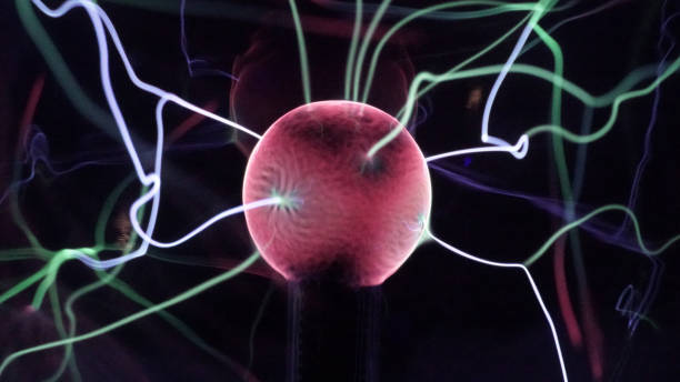 View of plasma ball with moving energy rays inside on black background. Abstract lightning in colors. Electricity in gas.