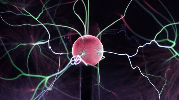 istock View of plasma ball with moving energy rays inside on black background. Abstract lightning in colors. Electricity in gas. 1180812806