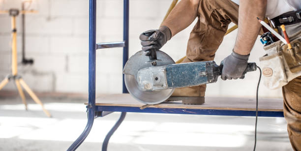 istock The industrial Builder works with a professional angle grinder to cut bricks and build interior walls. Electrician. 1180814604