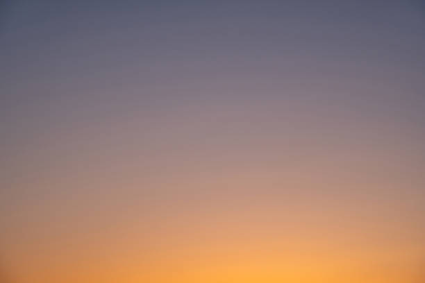 istock gray-orange background sky sunset without sun 1180819771