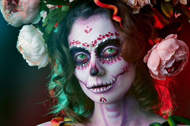 istock Halloween make up sugar skull beautiful model. Santa Muerte concept. 1180819838