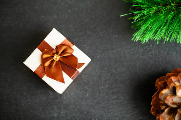 istock New year gift with christmas decorations on dark background 1180820787