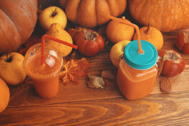 istock Pumpkins juice in bottles with pumpkins. 1180826103