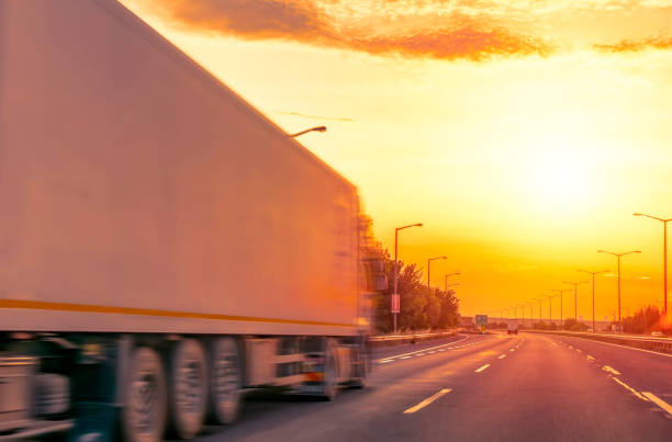 istock Truck with container on highway, cargo transportation concept. 1180826253