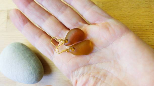 istock Earrings in a Woman's Hand 1180827036