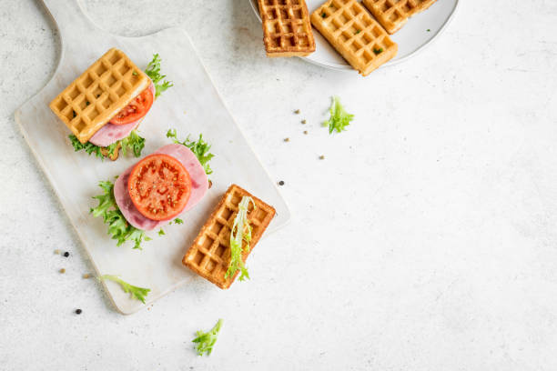 savory waffle sandwich with ham - morning tomato lettuce vegetable imagens e fotografias de stock