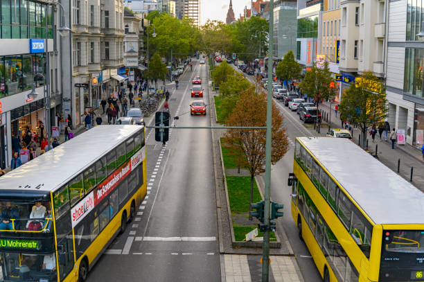 Berlin, Germany - October 5, 2019: Scene in a shopping street in Berlin-Steglitz with passersby, cars and busses.