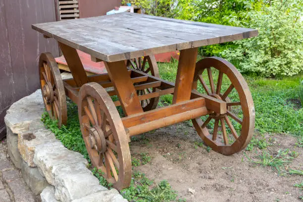 Old-fashioned empty wooden cart with 4 wheels.