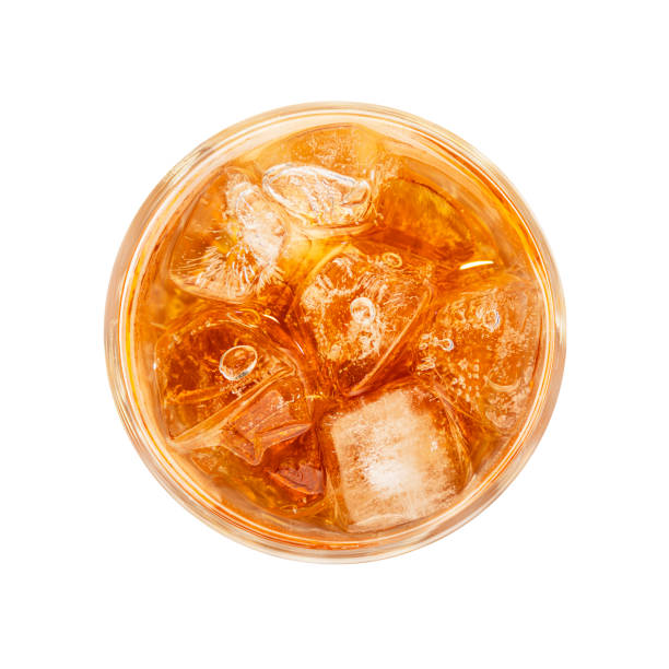 Glass of ice tea isolated on white Close up one big high glass of iced tea cold drink isolated on white background, elevated top view, directly above iced tea stock pictures, royalty-free photos & images