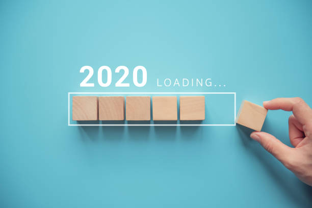 Loading new year 2020 with hand putting wood cube in progress bar. Loading new year 2020 with hand putting wood cube in progress bar. new year new life stock pictures, royalty-free photos & images
