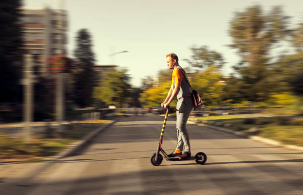 istock Hipster riding a scooter ,riding on Zebra Crossing 1180832353