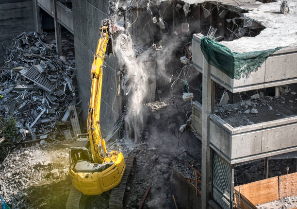 istock Demolishing building with heavy machinery 1180833278
