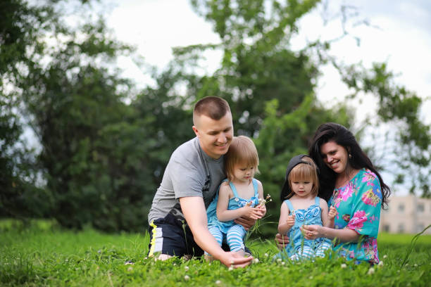 istock Mom with two daughters twins 1180835418