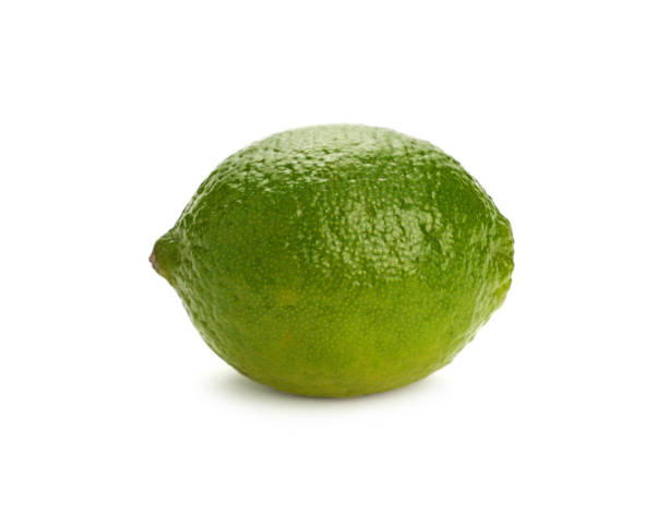 istock Close up one whole green lime isolated on white 1180835661