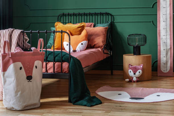 istock Fox theme in cute bedroom interior with green wall and orange bedding 1180836513