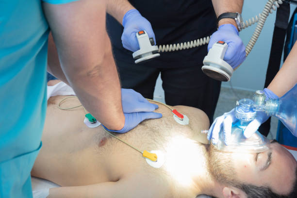 Doctors in emergency room working on unconscious patient