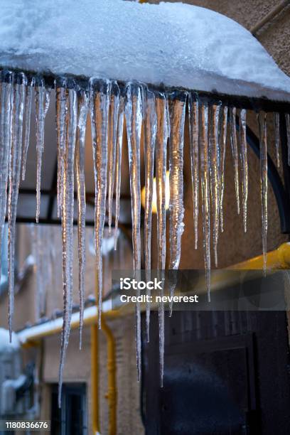 Backlit Icicles On A Roof Stock Photo - Download Image Now - Climate, Cold Temperature, Electric Lamp