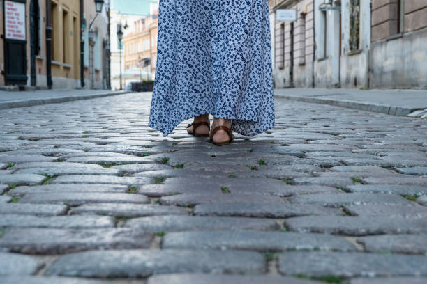 istock Female feet on the pavement 1180836782