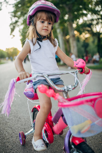 istock Cute girl learning to drive a bike 1180838083