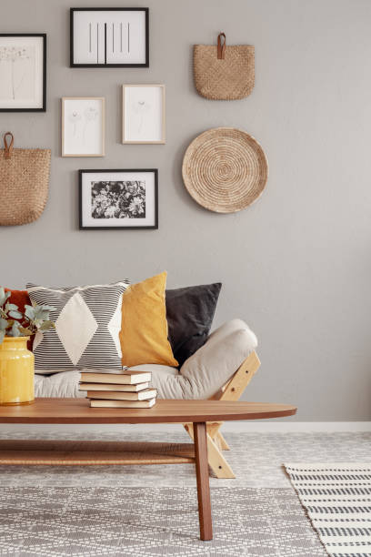 istock Beige scandinavian settee with patterned pillows in stylish living room interior 1180839834