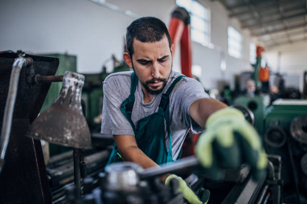 istock Young man working in metal factory 1180843320