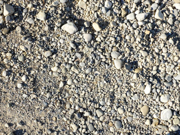 Close up of the gravel road in a sunny day. stock photo