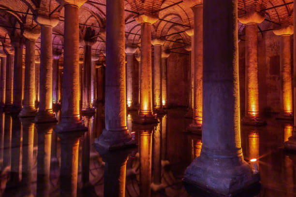 Historical Basilica Cistern of Istanbul Basilica Cistern is one the remarkable historical side if the side which sits under the Istanbul city. There are several hundred cisterns, but Basilica kept with little water, for public access inside the space. ancient arch architecture brick stock pictures, royalty-free photos & images