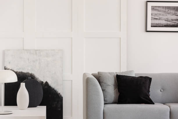 istock Comfortable grey sofa with pillows in elegant living room with scandinavian design 1180844382