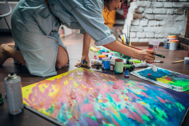istock Creative woman painting in her studio 1180844495