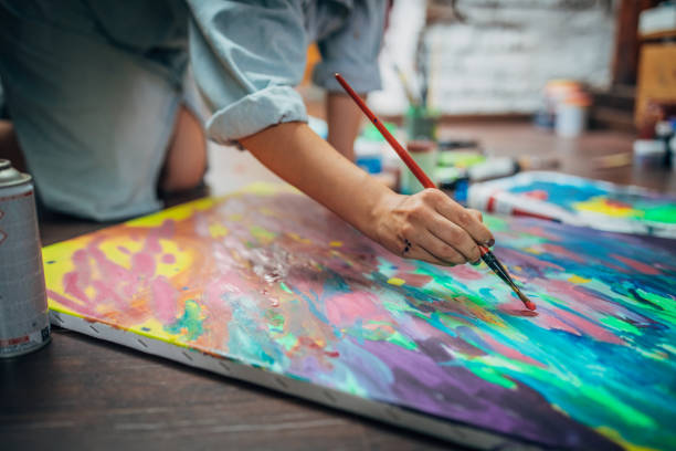 istock Creative woman painting in her studio 1180844628