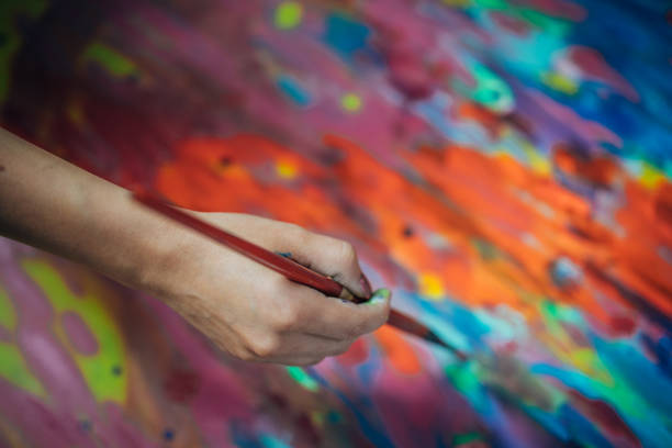 istock Creative woman painting in her studio 1180844671