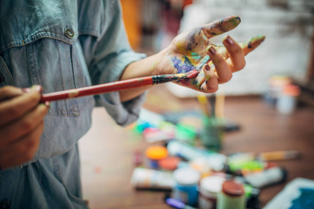 istock Creative woman painting in her studio 1180845192